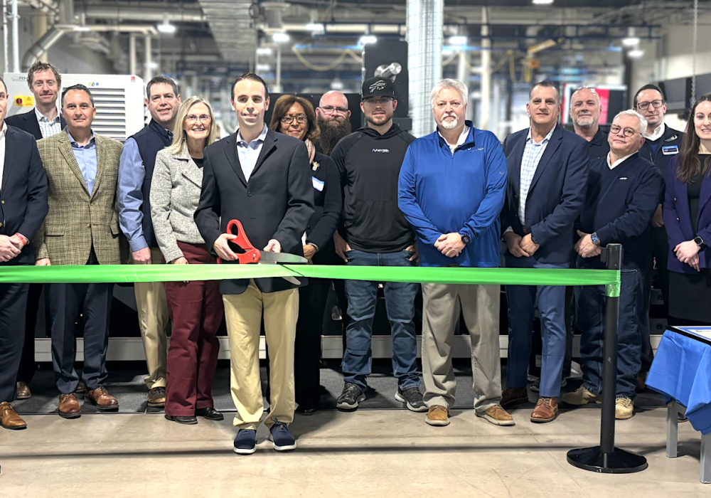 Photo shows large group at ribbon cutting ceremony